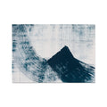 Abstract ink wave art print in shades of blue on a white background, with a textured appearance.