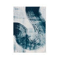 A framed abstract art print featuring swirls of dark blue on a light background.