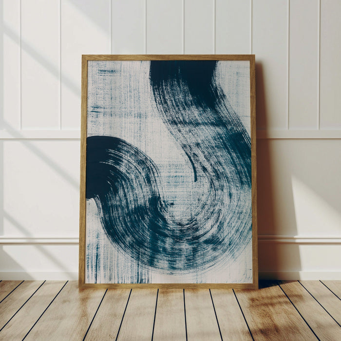 A framed abstract line art print featuring sweeping blue strokes on a white background, presented in a wooden frame. Abstract coastal art print.