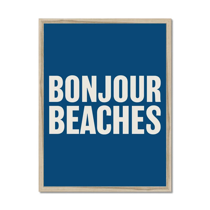 A colourful typography art print with the text 'BONJOUR BEACHES' in bold white letters on a navy blue background, framed on wall with a wooden frame.