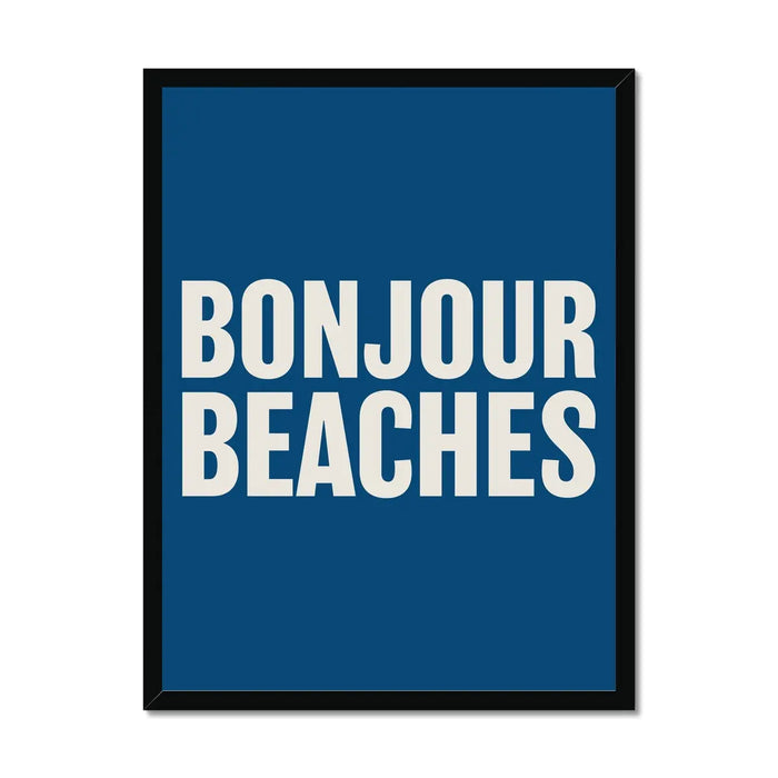 A colourful typography art print with the text 'BONJOUR BEACHES' in bold white letters on a navy blue background, framed on wall with black frame.
