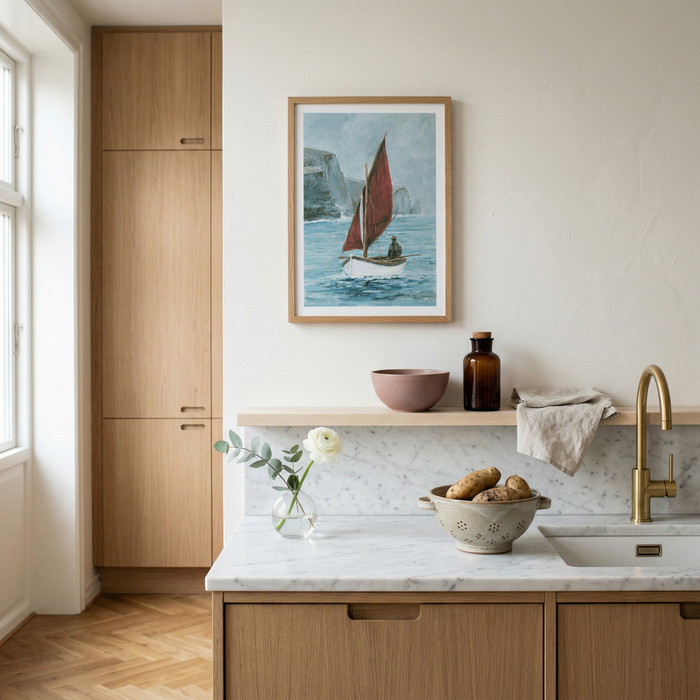 Modern kitchen with wooden cabinets, marble countertop, and framed fishing boat artwork on the wall.