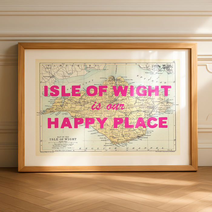 Framed custom map print of isle of wight with 'Isle of wight is our happy place' text on a wall.