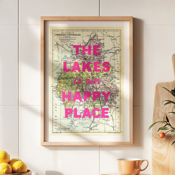 Framed custom map print with 'The Lakes is our happy place' text on a wall.