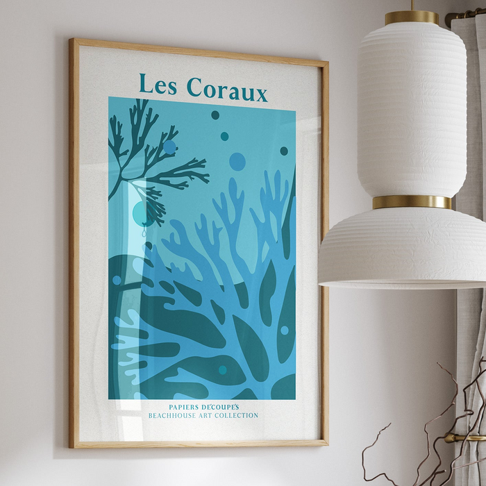 Framed coral art print with different shades of blue, framed with a natural wood frame.