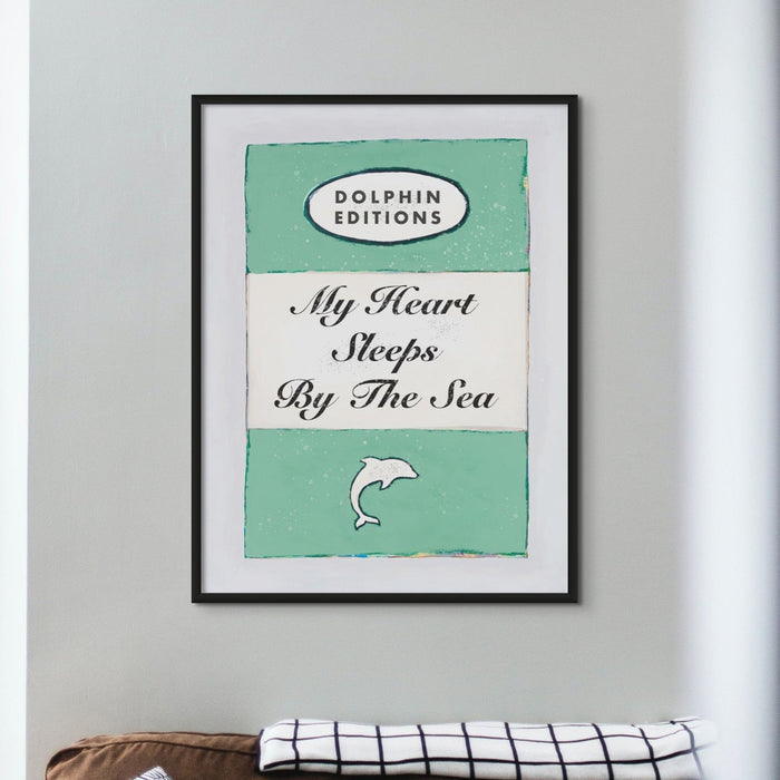 Framed art print of a vintage book cover with the title 'My Heart Sleeps By The Sea'.
