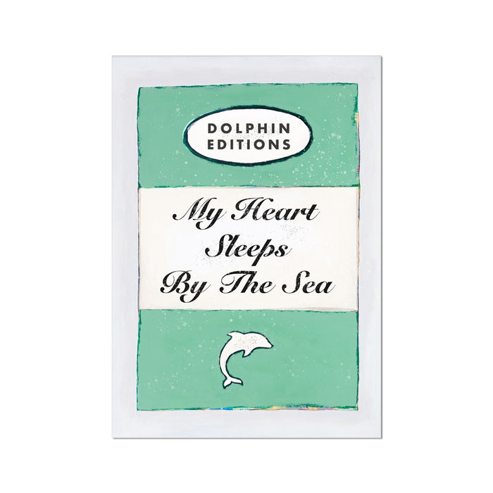 Unframed vintage style book cover art poster featuring the title 'My Heart Sleeps By The Sea' with a green background and a small illustration of a fish.