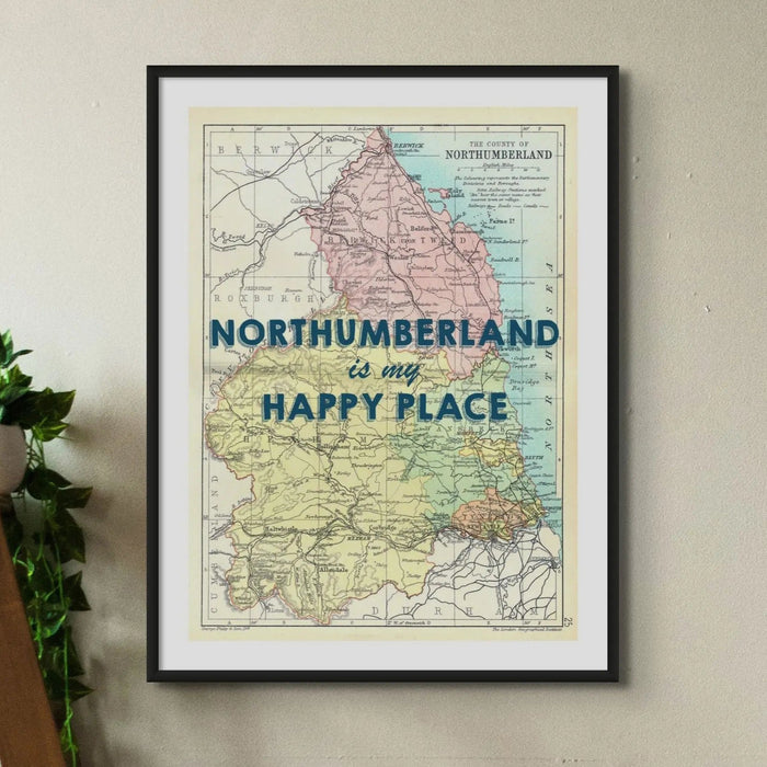 Vintage Northumberland map print with the text “Northumberland is my Happy Place” in blue lettering framed on wall.