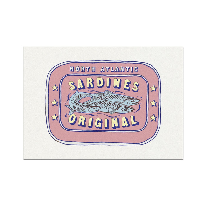 A framed art print of a label depicting a tin of North Atlantic Sardines, with bold red and yellow colours on a white background.