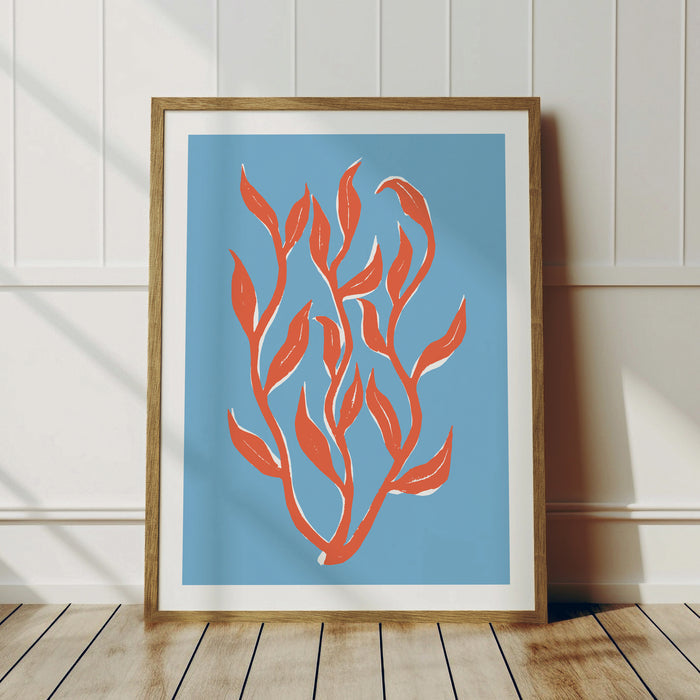 Framed colourful lino cut seaweed art print in coral red on a blue background.