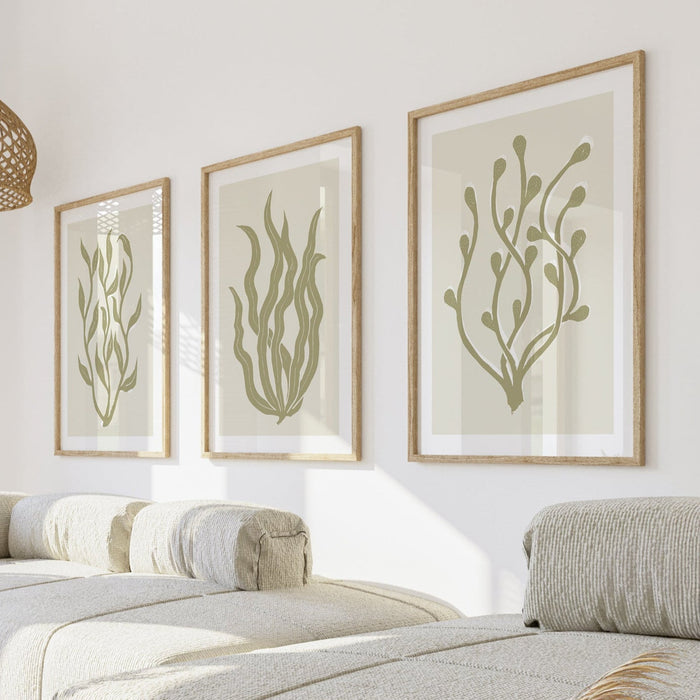 Set of three lino cut seaweed art prints in coastal living room.