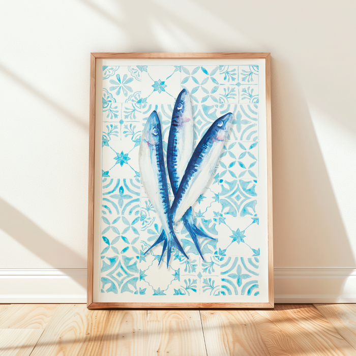 Framed artwork with blue fish on a patterned background, placed on a wooden floor. Sardine art print