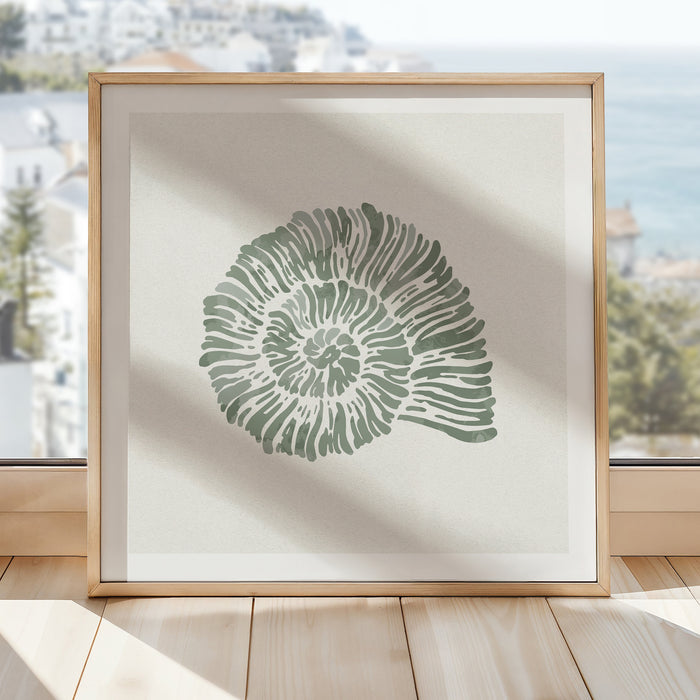Sage green spiral shell art print in natural wood frame styled in a bright coastal interior.