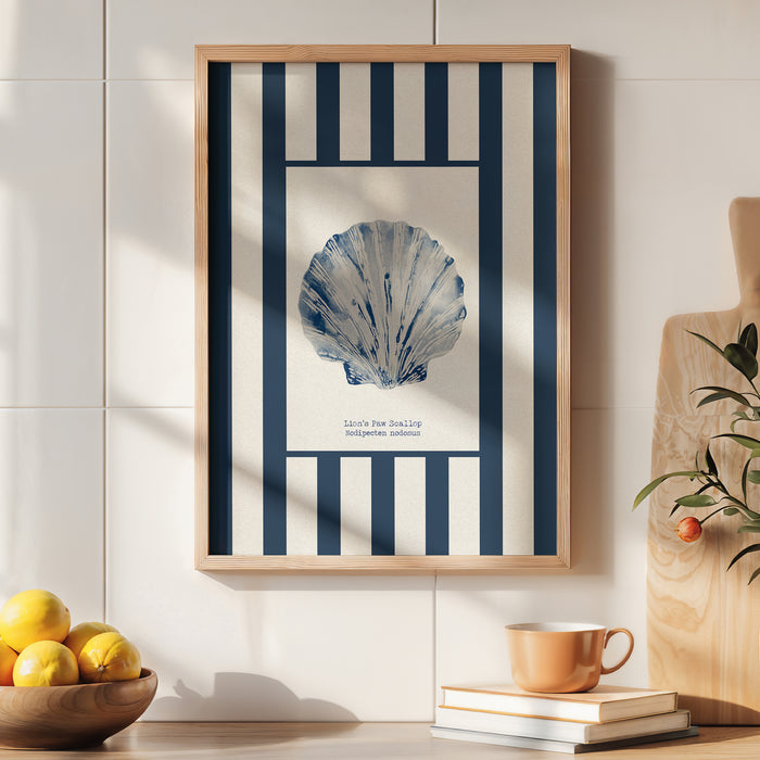 Framed artwork with a blue shell design on a white wall, next to a bowl of lemons and a cup.