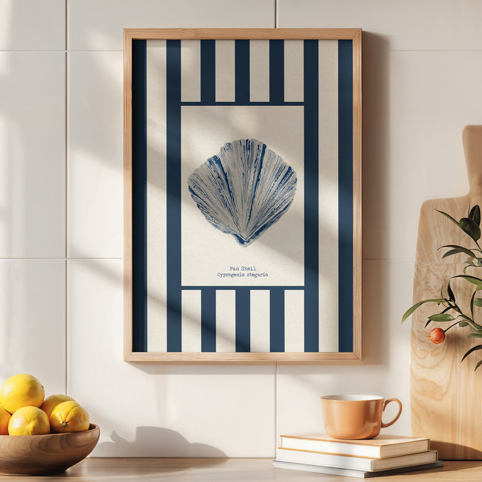 Framed blue shell print on a white background with navy stripes in kitchen.