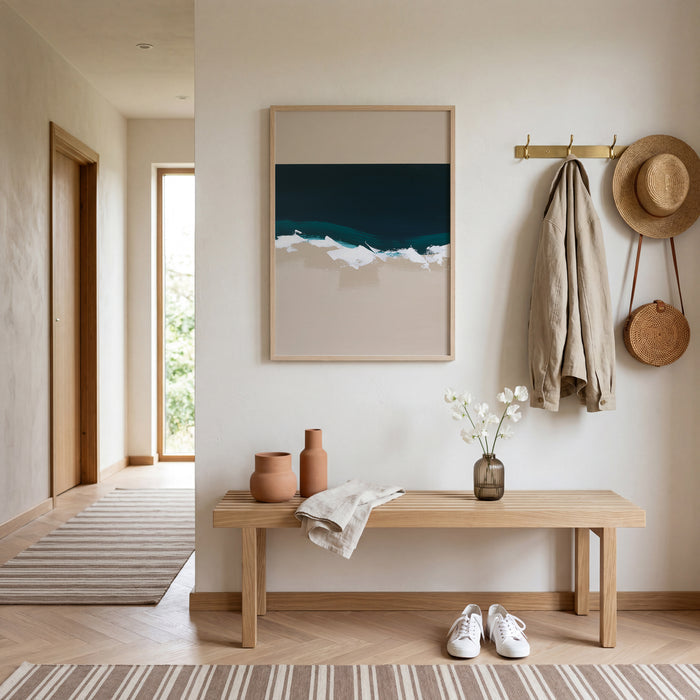 Modern hallway with wooden bench, artwork, and decor items.