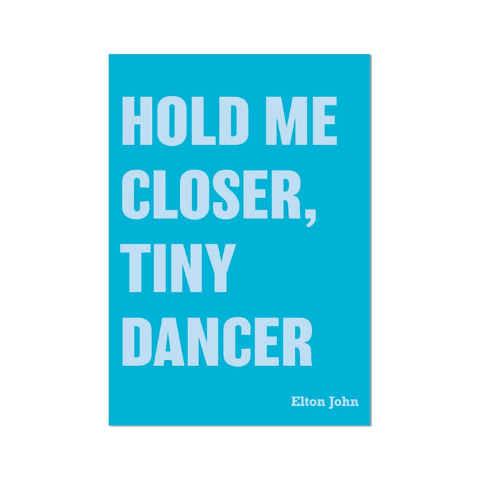A colorful art print with the text 'HOLD ME CLOSER, TINY DANCER' in white capital letters on a bright blue background, signed by Elton John at the bottom.
