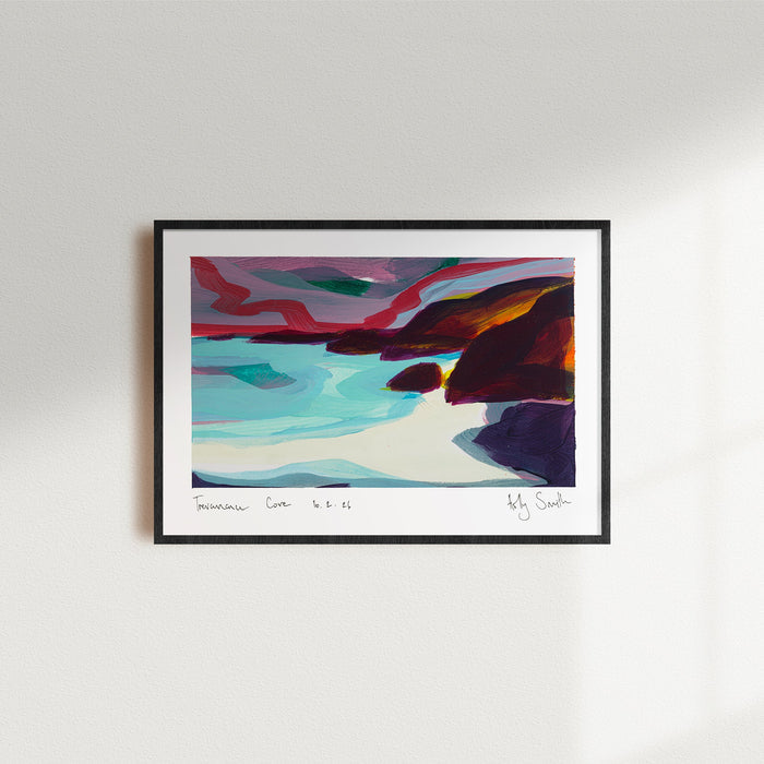 A framed abstract landscape art print featuring vibrant shades of red, teal, brown, and purple, hung on a clean white wall with soft window light casting shadows.