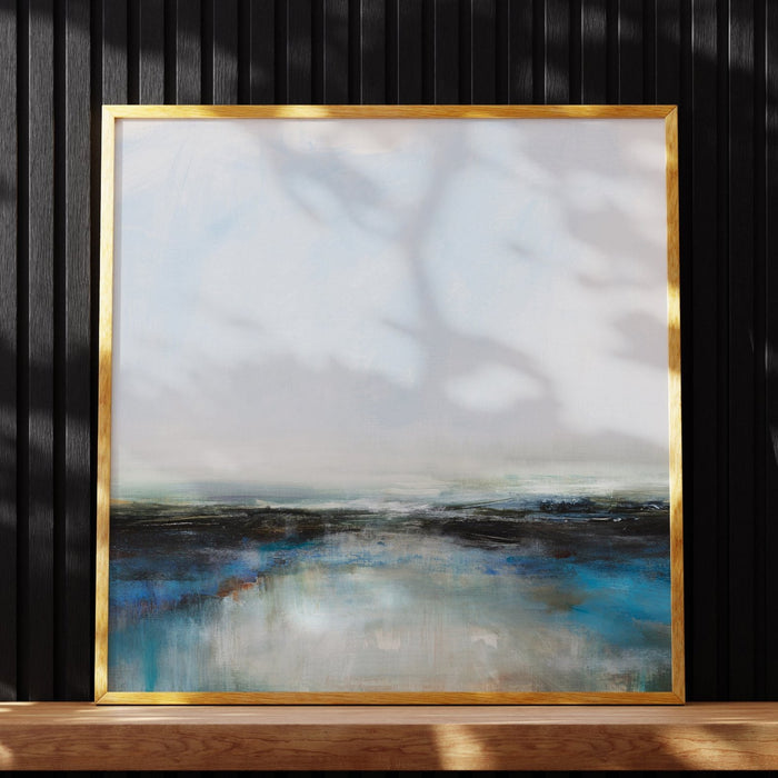A framed art print of an abstract sea painting resting on shelf with wooden frame.